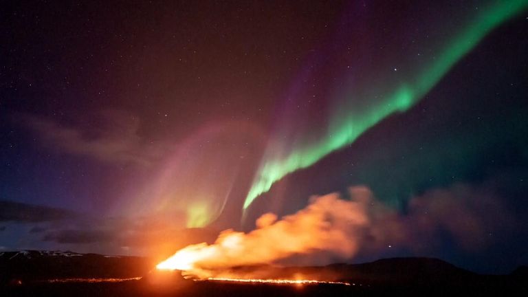 Northern Lights provide stunning backdrop to volcanic eruption in Iceland