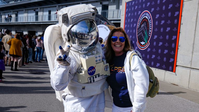 Tamra Sylvester poses with a person dressed as a NASA astronaut during a total eclipse viewing event at the Indianapolis Motor Speedway .
Pic: AP
