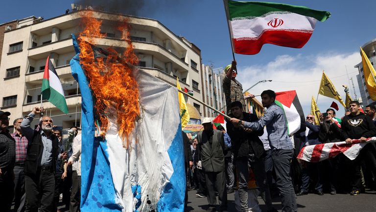 Iranians burn an Israeli flag during a rally marking Quds Day and the funeral of members of the Islamic Revolutionary Guard Corps who were killed in a suspected Israeli airstrike on the Iranian embassy last week. Pic: Reuters
