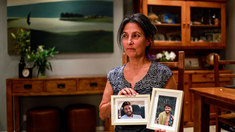 Rachel Goldberg, U.S.-Israeli mother of Hersh Goldberg Polin, which was taken hostage by Hamas militants into the Gaza Strip while attending a music festival in south Israel, holds photos of her son in their home in Jerusalem October 17, 2023 REUTERS/Ammar Awad