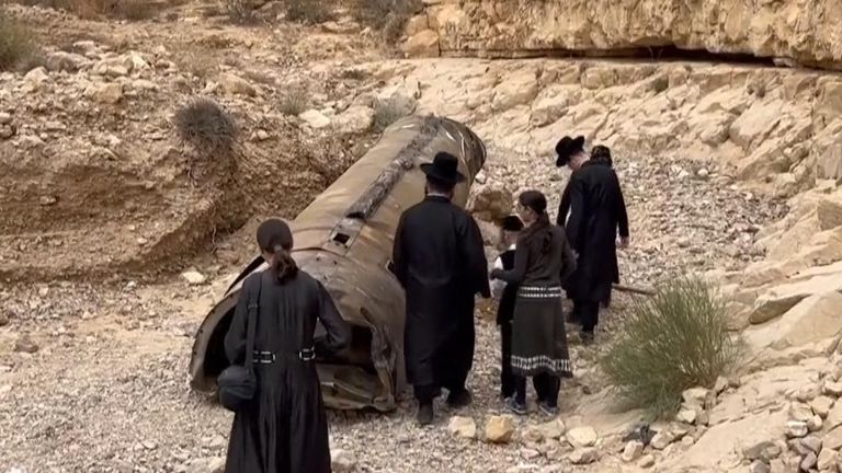 Jewish Ultra-Orthodox families inspect debris of what&#39;s believed to be an intercepted Iranian surface-to-surface missile
