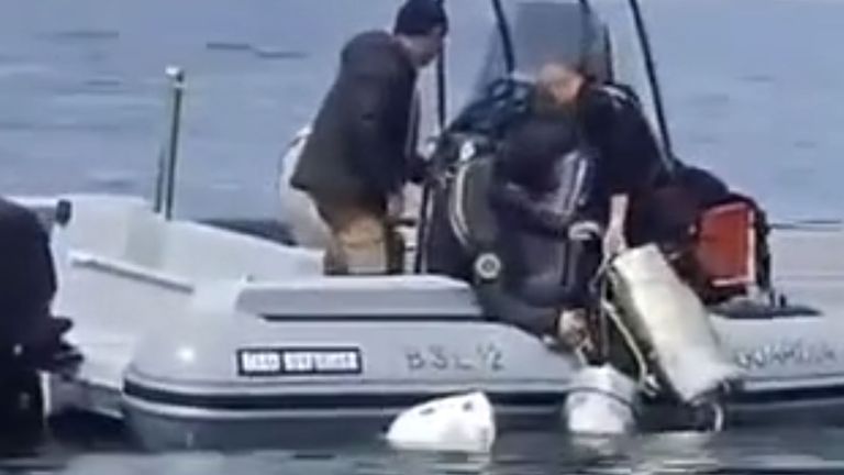 Officers haul the drugs aboard a boat. Pic: Guardia di Finanza/Polizia di Stato