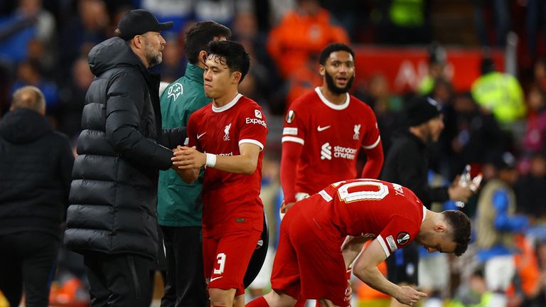 Soccer Soccer - Europa League - Fourth Final - First Leg - Liverpool v Atalanta - Anfield, Liverpool, Britain - April 11, 2024 Liverpool's Wataru Endo with manager Jurgen Klopp after being substituted REUTERS/Molly Darlington