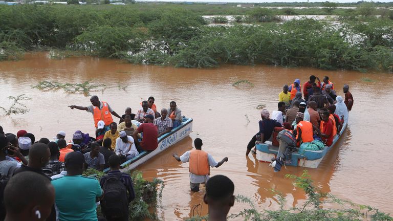 People cross a flooded area where another boat carrying a group of people has capsized at Mororo, border of Tana River and Garissa counties, North Eastern Kenya.
Pic: AP