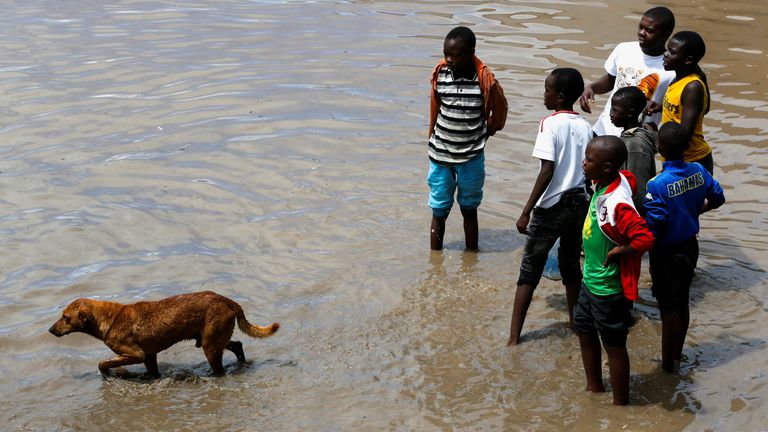 A group stands in floodwater in Machakos county, near Kenya's capital. Pic: Reuters