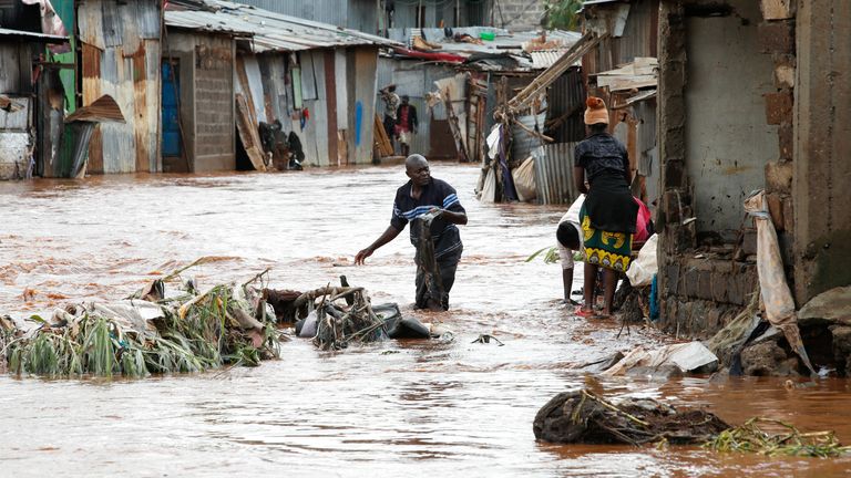 Residents try to recover their belongings in Nairobi after flooding. Pic: Reuters