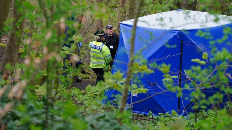 Police officers by a forensic tent at Kersal Dale, where a major investigation has been launched after human remains were found on Thursday evening. Greater Manchester Police (GMP) said officers were called by a member of the public who found an "unknown item wrapped in plastic". Pic: PA 