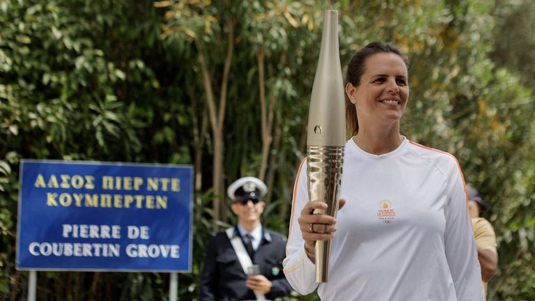 The second torchbearer French swimmer Laure Manaudou, carries an unlit touch before the start of the torch relay after the flame lighting ceremony for the Paris 2024 Olympics.  
