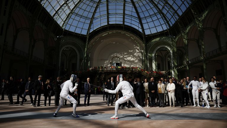 Mr Macron watches a fencing demonstration by the French fencing team during his visit today. Pic: Reuters