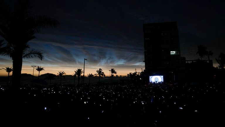 People use their mobile phones as the sky darkens during a total solar eclipse in Mazatlan, Mexico.
Pic: AP