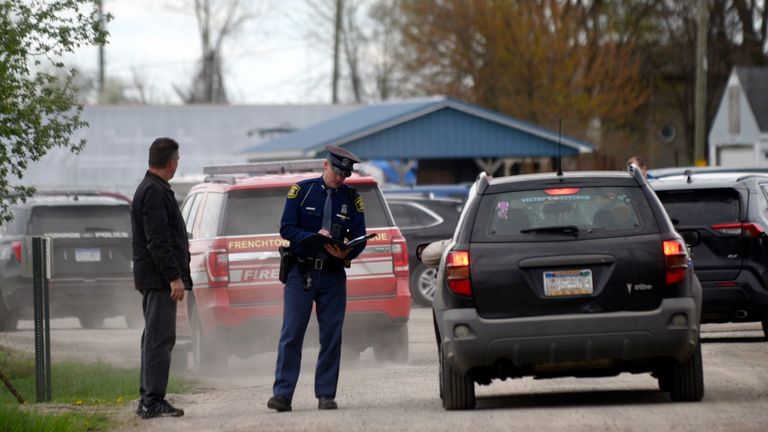 A law enforcement official monitors the perimeter of the Swan Creek Boat Club after a driver crashed a vehicle through a building where a children&#39;s birthday party was taking place, Saturday, April 20, 2024, in Berlin Township, Mich. (Kathleen Kildee/Detroit News via AP)
