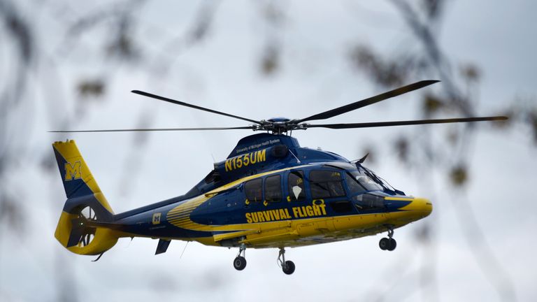 A University of Michigan Health System Survival Flight responds to the Swan Creek Boat Club after a driver crashed a vehicle through a building where a children's birthday party was being held, Saturday, April 20, 2024 , in Berlin Township, Michigan.  (Kathleen Kildee/Detroit News via AP)