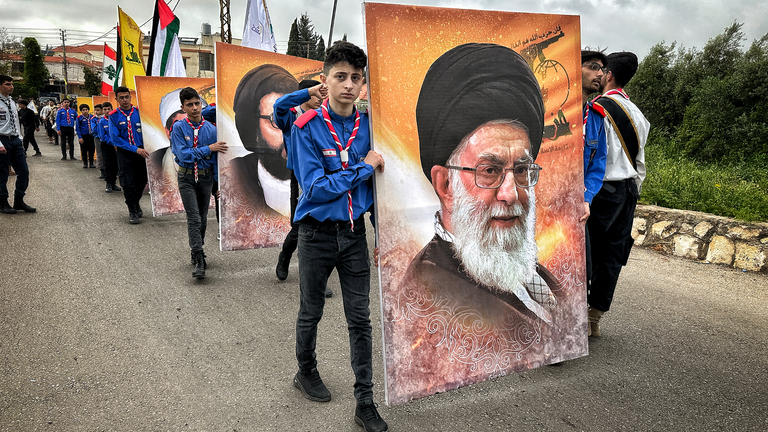 Posters of the Iranian supreme leader Ayatollah Ali Khamenei at the funeral