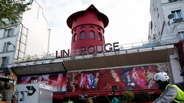 Sails of the landmark red windmill atop the Moulin Rouge, Paris' most famous cabaret club, are seen on the ground after a fall off during the night in Paris, France, April 25, 2024. REUTERS/Benoit Tessier
