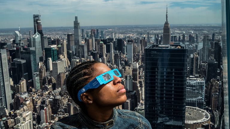 A person watches the start of the eclipse in New York.
Pic: Reuters