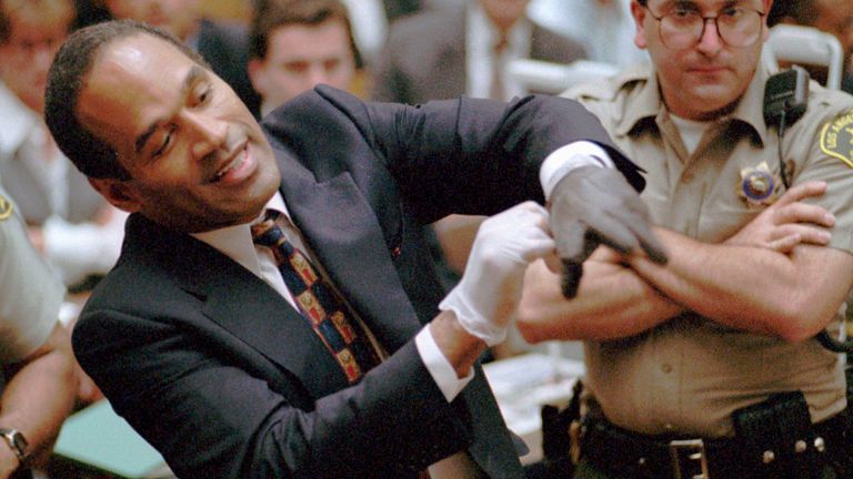 OJ Simpson grimaces as he tries on one of the leather gloves prosecutors say he wore the night his ex-wife Nicole Brown Simpson and Ron Goldman were murdered.
Pic: AP