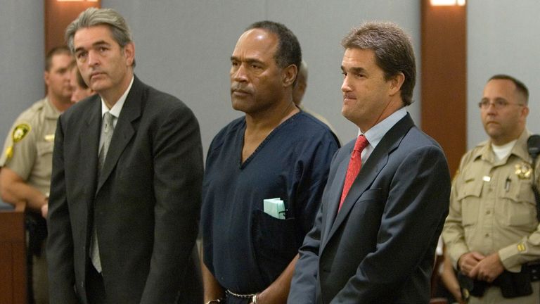 O.J. Simpson is flanked by his lawyers Yale Galanter, right, and Gabriel Grasso during Simpson&#39;s arraignment in a Clark County Justice courtroom.
Pic: AP