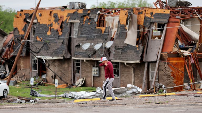 A man walks past tornado damage in Sulfur, Oklahoma Pic: The Oklahoman/AP