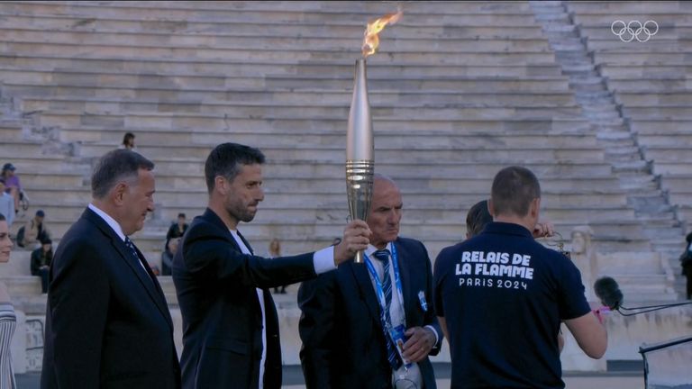 Olympic torch handed over from Greece to France at ceremony in Athens
