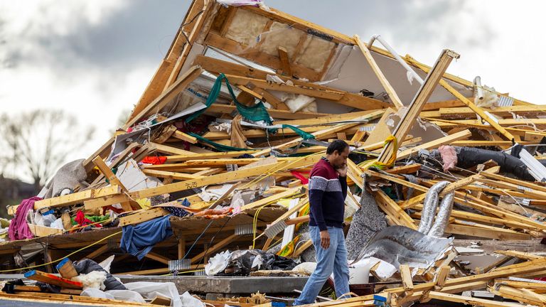Gopala Penmetsa walks past his home after it was flattened by a tornado near Omaha, Neb., Friday, April 26, 2024. (Chris Machian/Omaha World-Herald via AP)