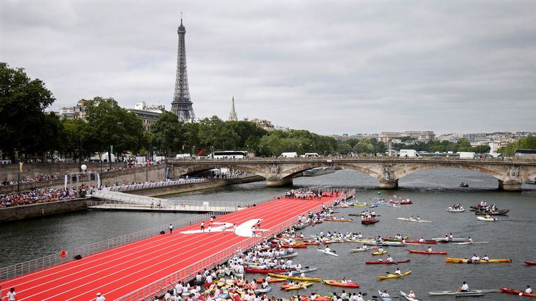FILE PHOTO: A general view from the Pont Alexandre III bridge shows an athletics track that floats on the River Seine, with the Eiffel tower in the background, in Paris, France, June 23, 2017 as Paris is transformed into a giant Olympic park to celebrate International Olympic Days with a variety of sporting events for the public across the city during two days as the city bids to host the 2024 Olympic and Paralympic Games. REUTERS/Charles Platiau/File Photo