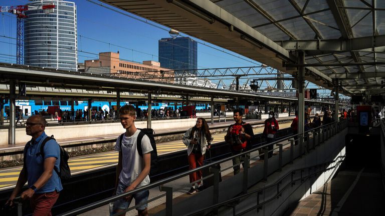 Passengers walk in the Part-Dieu train station during a railway strike, in Lyon, central France, Wednesday, July 6, 2022. A strike by railway workers demanding higher pay amid cost of living increases is interrupting train service in France. National railway company SNCF said about one in four high-speed trains was canceled on Wednesday. It says regional service such as suburban trains in the Paris region is experiencing disruptions. (AP Photo/Laurent Cipriani)