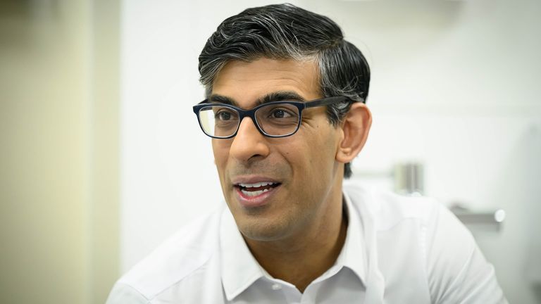 Rishi Sunak speaks with medical staff during a visit to  Woking Community Hospital.
Pic: PA