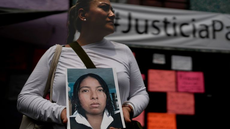 Alejandra Jiménez holds an image of Amarirany Roblero who went missing 12 years ago. pic: AP