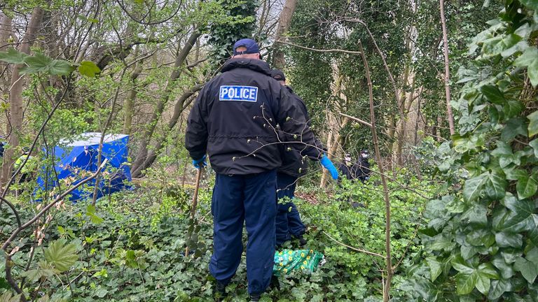 Police officers search the undergrowth at Kersal Dale