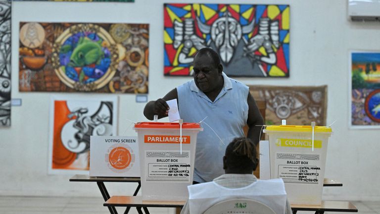 Pic: AAP/Mick Tsikas via Reuters. A voter casts his vote during the national election in the capital Honiara, Solomon Islands, April 17, 2024. 