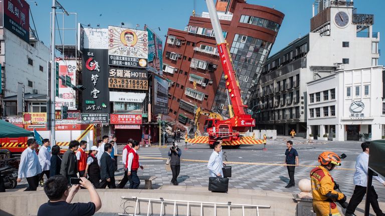 Taiwan's president and vice-president visit the site of a partially collapsed building. Pic: AP