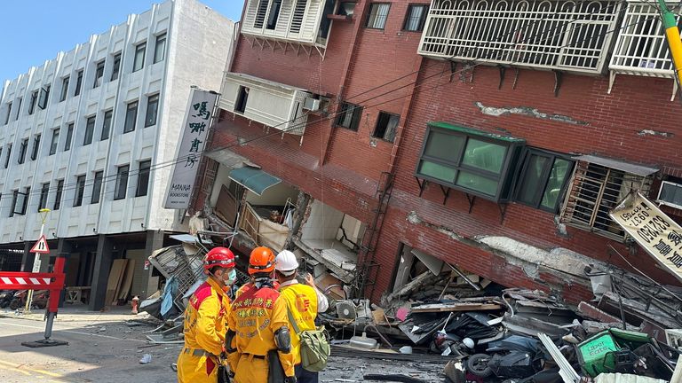 Firefighters work at the site where a building collapsed following the earthquake, in Hualien, Taiwan.
Pic:Taiwan&#39;s National Fire Agency/Reuters