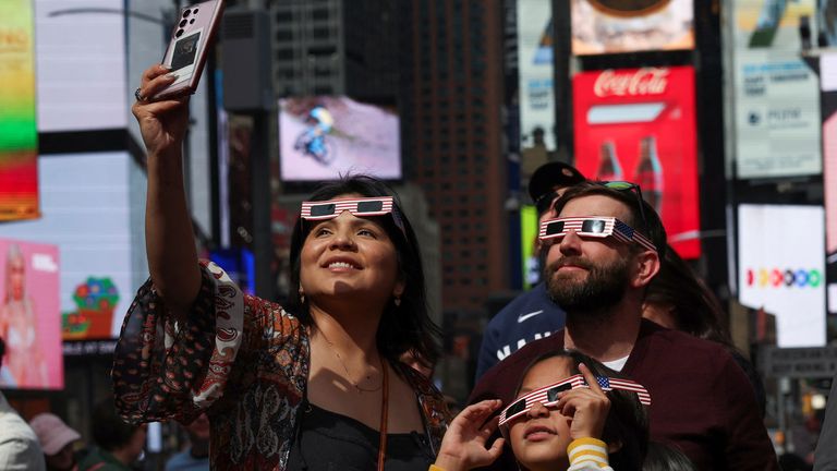 People watch the eclipse in Times Square 
Pic: Reuters
