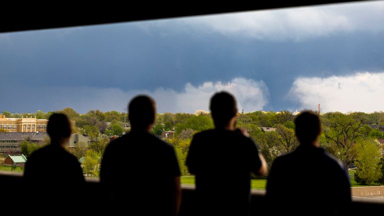 Ally Mercer, Gabe Sedlacek Kaleb Andersen and Austin Young watch a tornado from a seventh-floor parking garage, Friday, April 26, 2024, in Lincoln, Neb.  (Kenneth Ferriera/Lincoln Journal Star via AP)