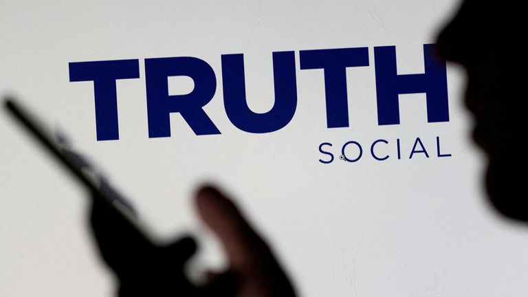 FILE PHOTO: The Truth social community logo is seen displayed in the abet of a girl maintaining a smartphone in this picture illustration taken February 21, 2022. REUTERS/Dado Ruvic/Illustration/File Portray