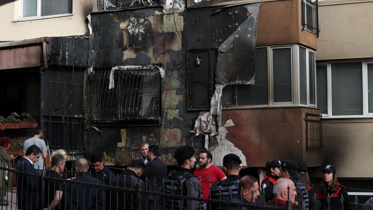 Police officers and rescuers stand in front of a building where a fire broke out during daytime renovation work at a nightclub in Istanbul, Turkey April 2, 2024. REUTERS/Murad Sezer
