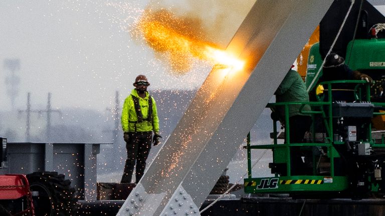 Workers dismantling parts of the collapsed Francis Scott Key Bridge using an exothermic cutting torch. Pic: AP 