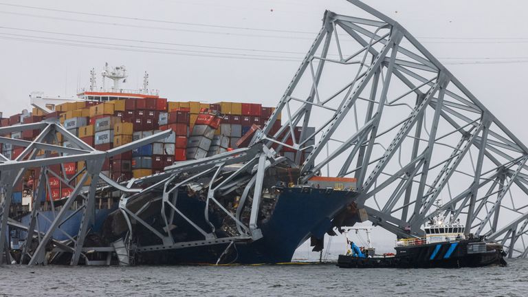 The wreckage of the bridge has been stuck across the container in the weeks since the incident. Pic: AP