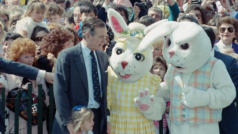 President George Bush and his granddaughter, Marshall, are greeted by a couple of oversized bunnies and several hundred children during the annual Easter Egg Roll on the White House South Lawn, April 16, 1990. (AP Photo/Charles Tasnadi)


