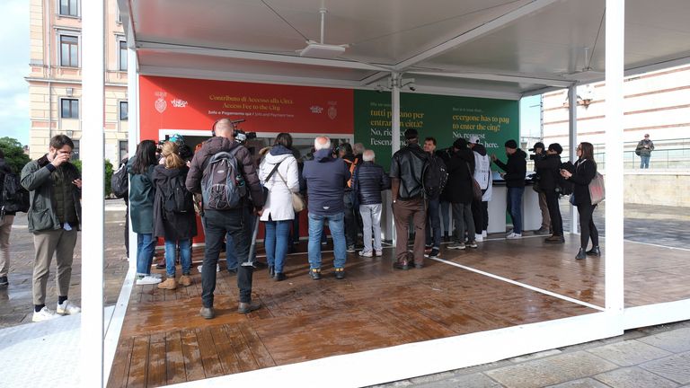 Tourists queue at the information centre to register and receive a QR code. Pic: Reuters