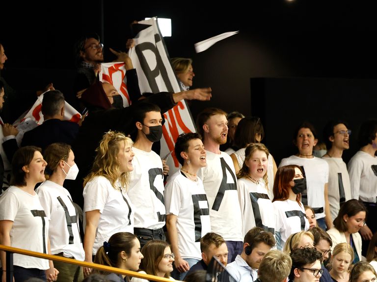 Protesters briefly interrupted the vote, wearing shirts reading &#39;this pact kills&#39;. Pic: AP