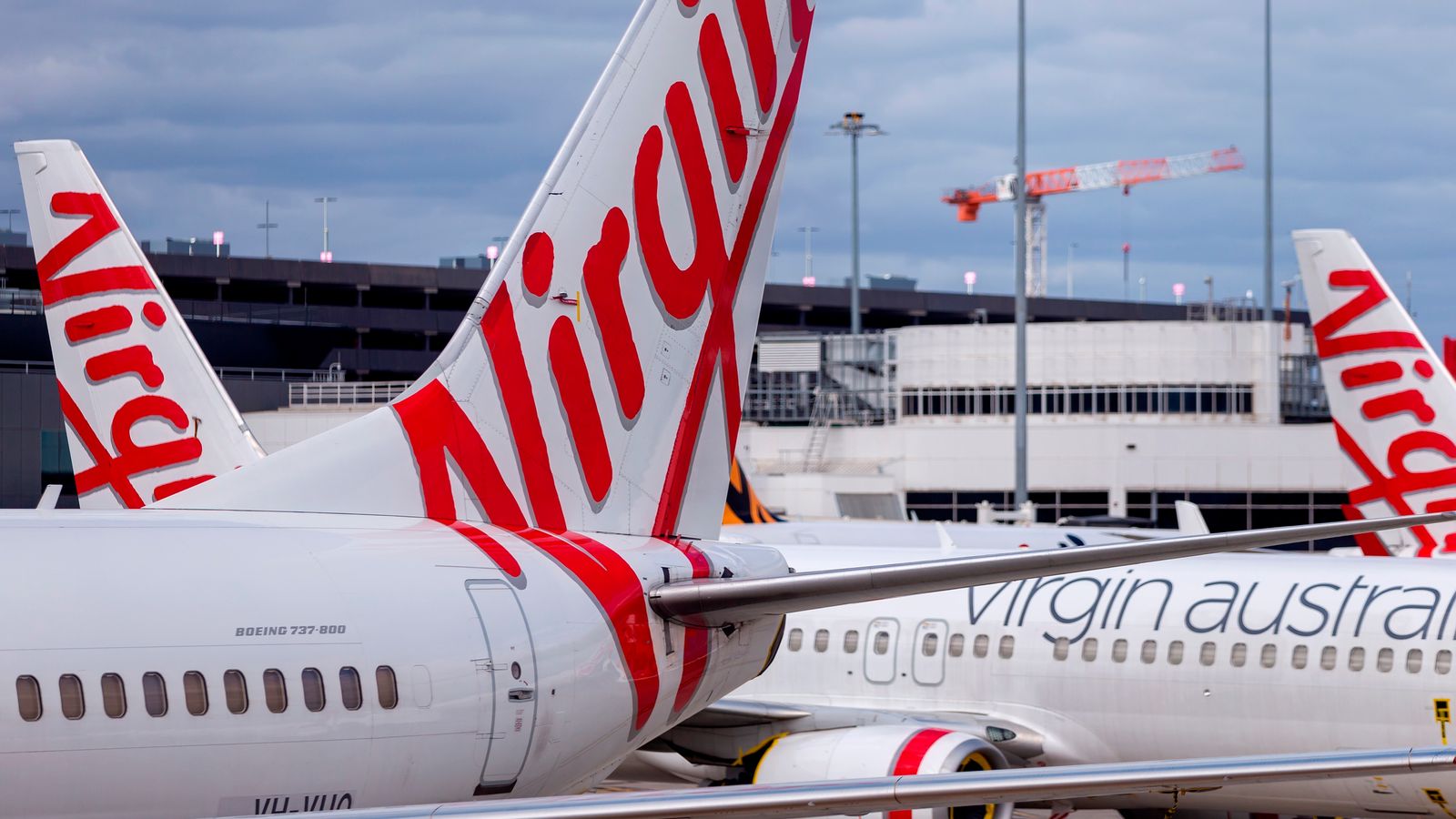 Man who 'ran through Virgin Australia plane naked and knocked over attendant' arrested