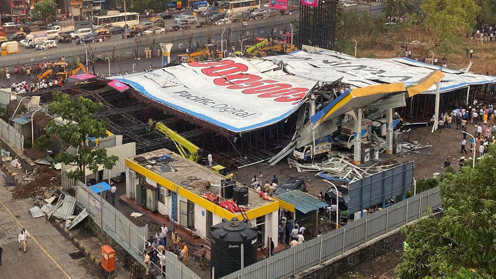 At least 14 killed and dozens feared trapped after huge billboard collapses in Mumbai