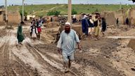 People gather around their damaged houses after heavy flooding in Baghlan province in northern Afghanistan Saturday, May 11, 2024. Flash floods from seasonal rains in Baghlan province in northern Afghanistan killed dozens of people on Friday, a Taliban official said. (AP Photo/Mehrab Ibrahimi)