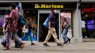 People walk past a Dr. Martens store in Manchester, Britain, May 26, 2023. REUTERS/Jason Cairnduff