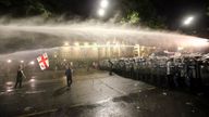 Riot police use a water cannon during an opposition protest against "the Russian law" near the Parliament building in Tbilisi, Georgia, on Wednesday, May 1, 2024. Clashes erupted between police and opposition demonstrators protesting a new bill intended to track foreign influence that the opposition denounced as Russia-inspired. (AP Photo/Zurab Tsertsvadze)