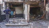 People look at the burnt building of a baby care center in New Delhi, India, Sunday, May 26, 2024. A fire broke out in the care center on Saturday night killing six infants, a fire service officer said on Sunday. (AP Photo/Dinesh Joshi)