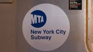 FILE - The MTA logo is seen on the side of a New York City subway car, April 23, 2020, in the Queens borough of New York. A man set a cup of liquid on fire and tossed it at fellow subway rider in New York City, setting the victim's shirt ablaze and injuring him. The random attack happened on a No. 1 train in lower Manhattan on Saturday afternoon, May 25, 2024, city police said, adding that the suspect was in custody. (AP Photo/Mark Lennihan, File)