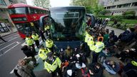 Police try and stop protesters forming a blockade around a coach which is parked near the Best Western hotel in Peckham.
Pic: PA