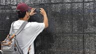 It apparently takes more than a black screen to stop this tourist from capturing a shot of the iconic mountain. Pic: AP